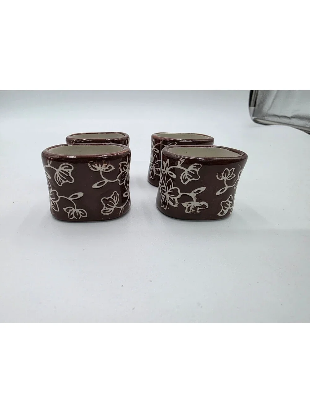 Set of 4 Brown Ceramic Napkin Rings with White Floral Design